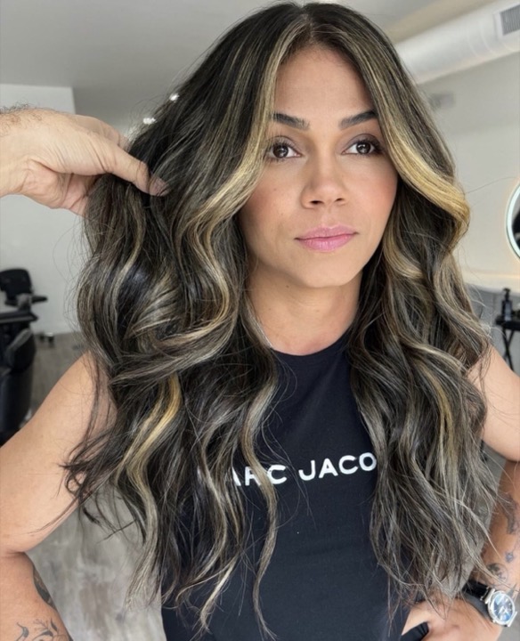 Dark hair with face-framing highlights
